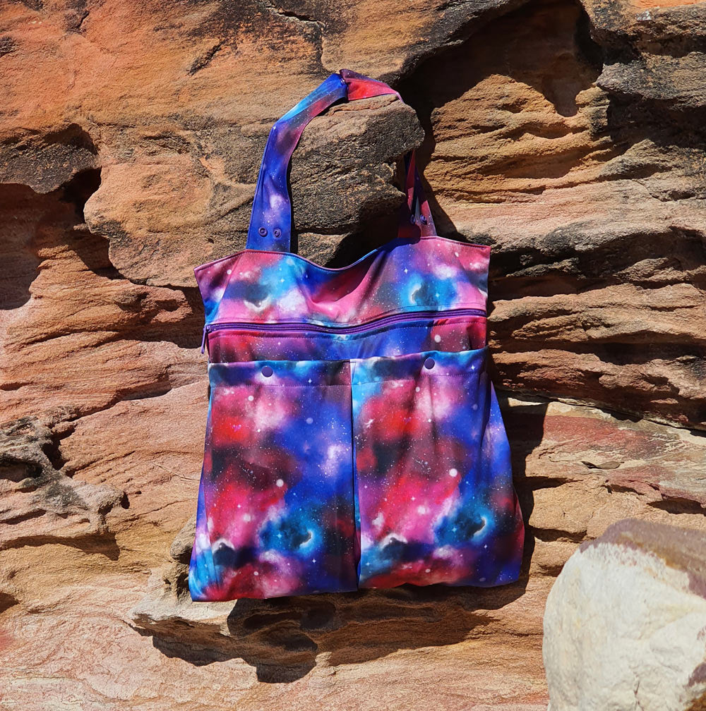 galaxy water resistant bag hanging on rock